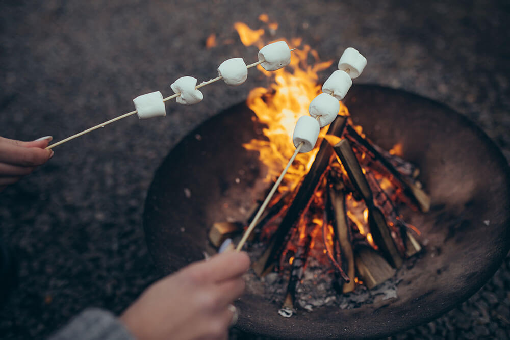 toasting marshmallows around a fire pit